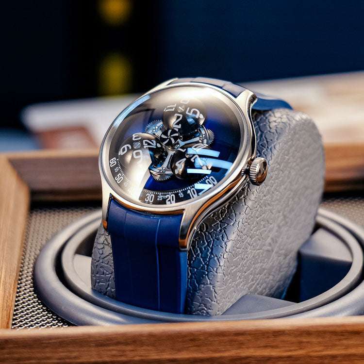 Close-up of the YOYG watch dial showing the hour display function with three rotating spheres